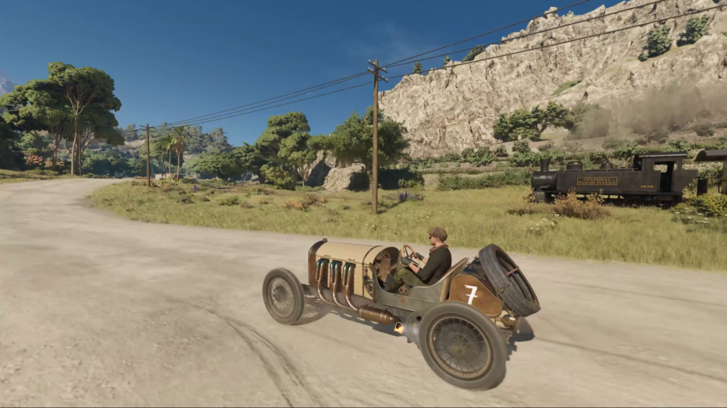 Гонщик ведёт ретро-автомобиль по сельской дороге